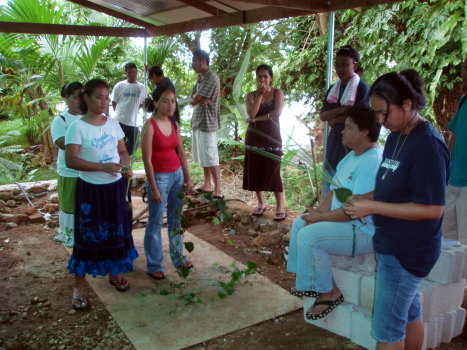 Students hold lemon grass and the native Pohnpei pepper vine