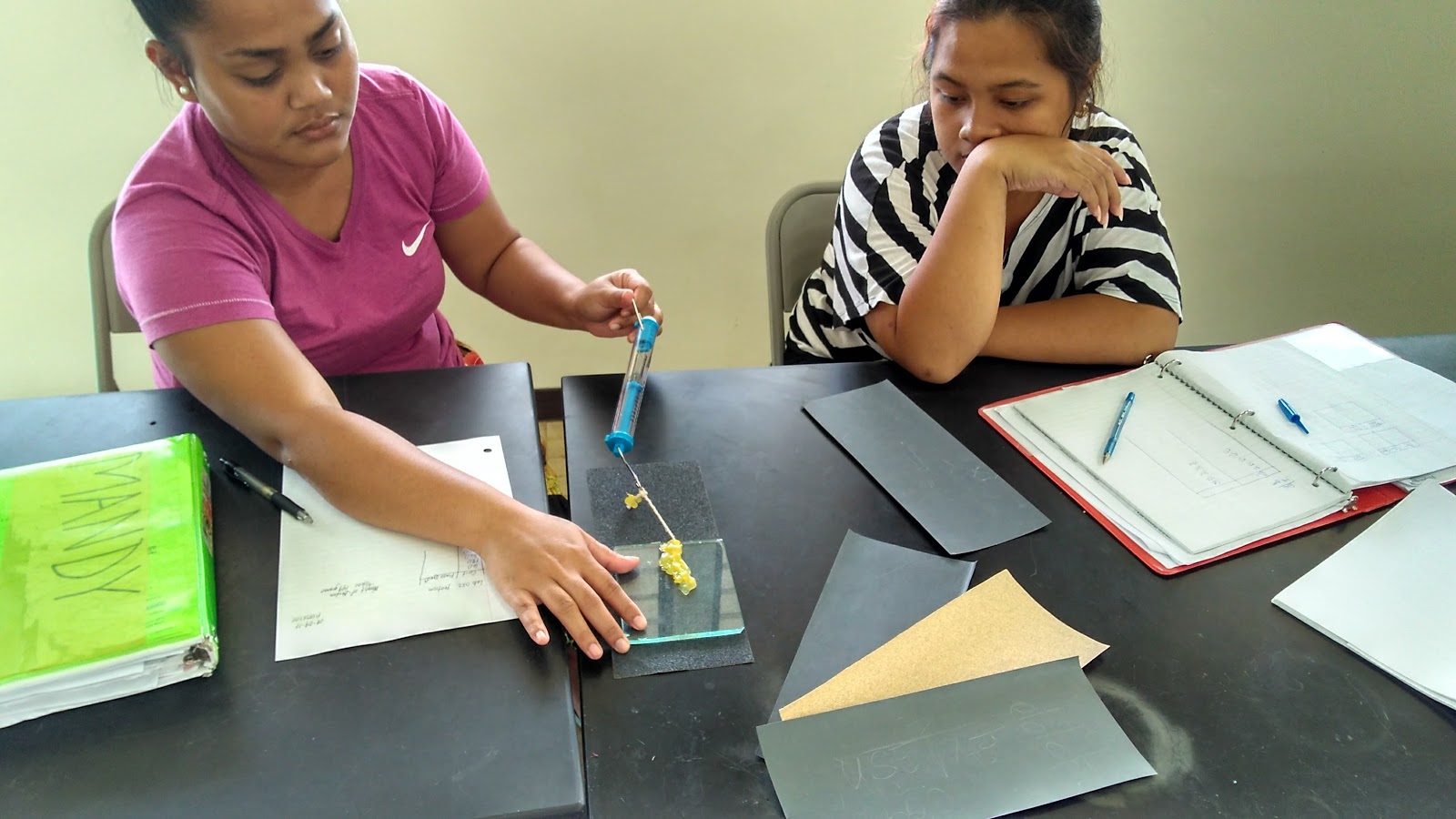 Students exploring the relationship between sandpaper grit and the force of friction