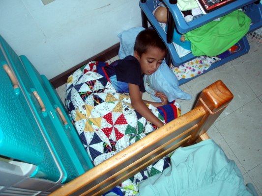 He curled up in a ball, the wall, the dresser, the bed, and a set of shelves forming the four walls of his bed basket.