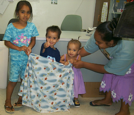 kids holding Christmas fabric proposal for Kosrae... (82K)