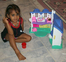 Sharisey with her house.