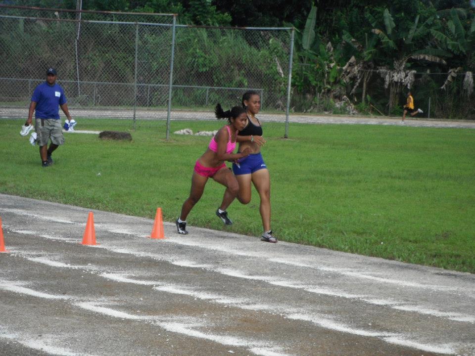 Hand-off of the stick in the Pohnpei Liberation day female 4x100 meter relay, Relo passes to Mihter for the win.